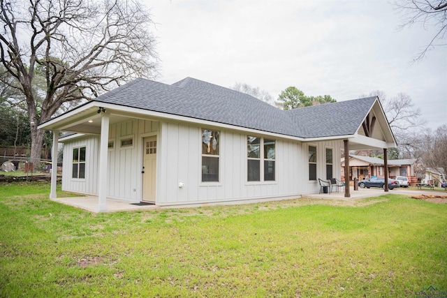 rear view of house featuring a yard and a patio area