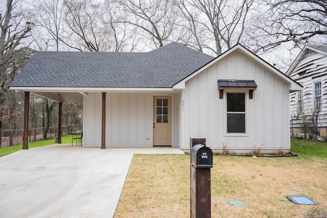 view of front of house with a front yard and a carport