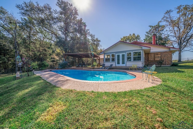 view of swimming pool with a lawn and a patio