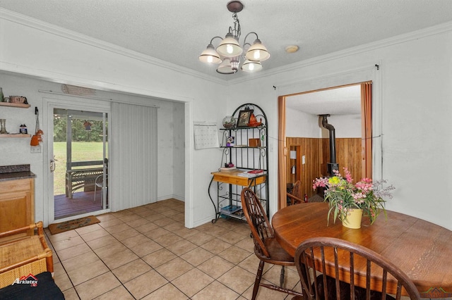 dining area with crown molding, light tile patterned flooring, a chandelier, and a textured ceiling