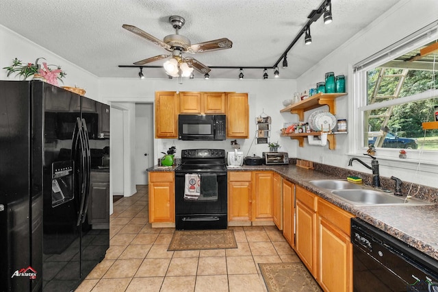 kitchen with black appliances, light tile patterned floors, sink, and a textured ceiling