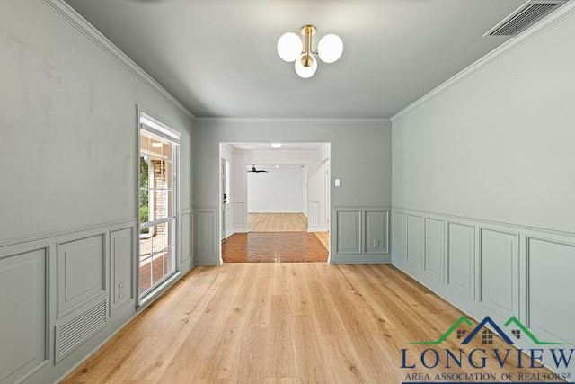 interior space featuring ceiling fan, light hardwood / wood-style flooring, and ornamental molding