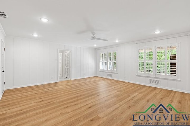 unfurnished room with ceiling fan, crown molding, and light wood-type flooring