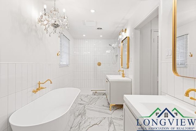 bathroom featuring vanity, tile walls, independent shower and bath, and a notable chandelier