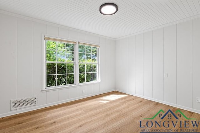 unfurnished room with hardwood / wood-style flooring