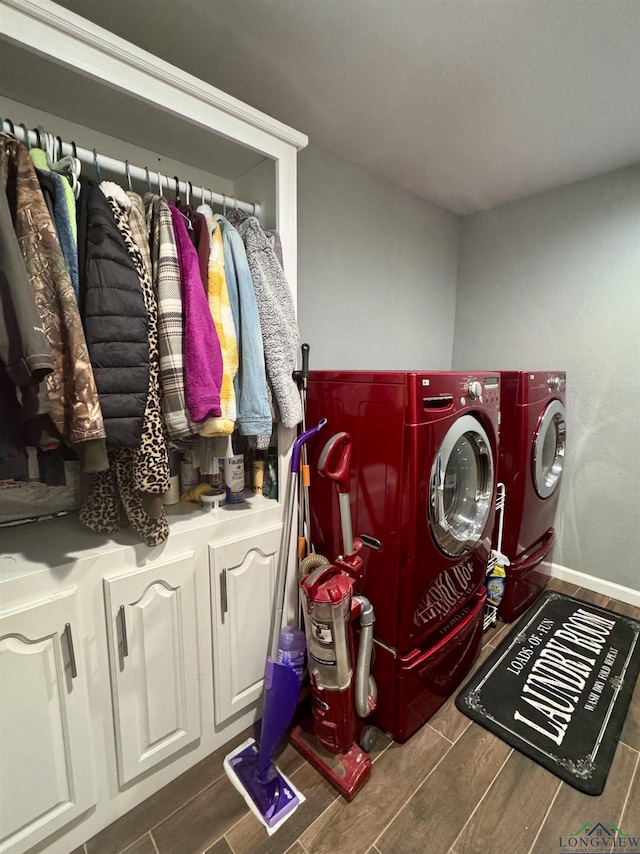 washroom featuring washer and clothes dryer and cabinets