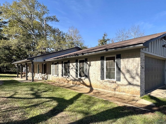 exterior space featuring a garage and a lawn