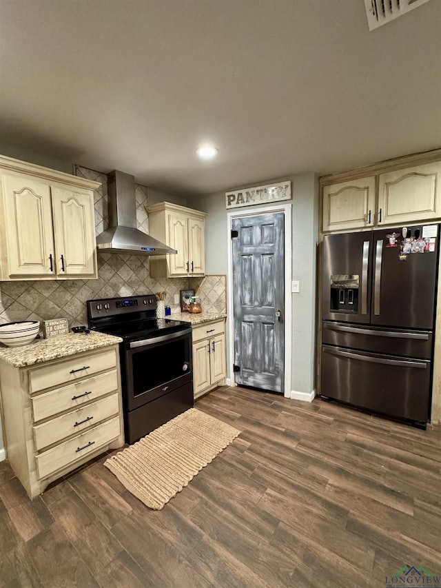 kitchen featuring tasteful backsplash, black refrigerator with ice dispenser, electric range oven, dark hardwood / wood-style floors, and wall chimney range hood