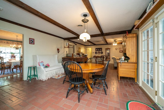 dining area with ceiling fan with notable chandelier