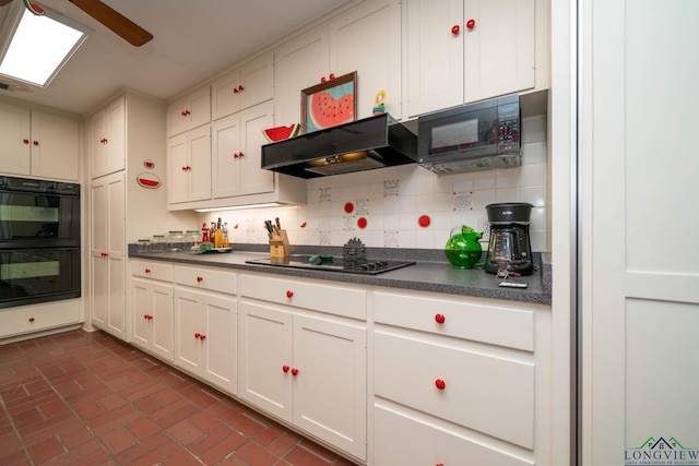 kitchen featuring backsplash, white cabinetry, black appliances, and ventilation hood