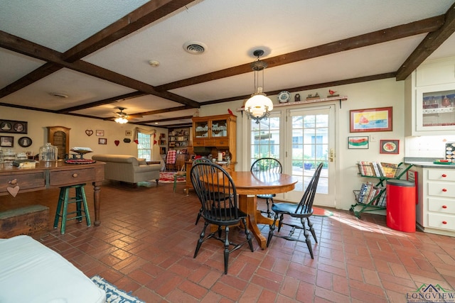 dining space with ceiling fan and beam ceiling