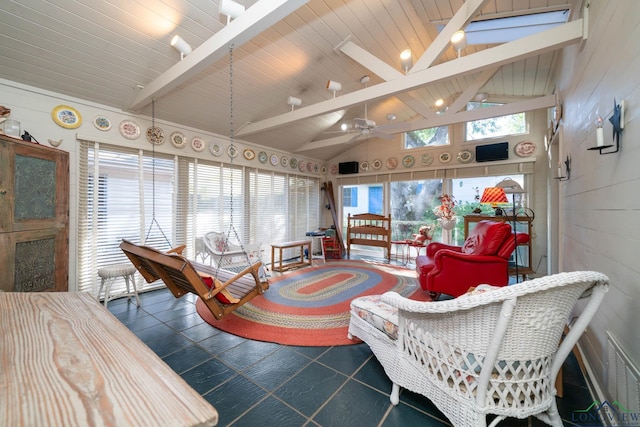 sunroom / solarium with vaulted ceiling with beams, ceiling fan, and wooden ceiling