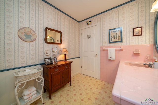 bathroom with sink and ornamental molding