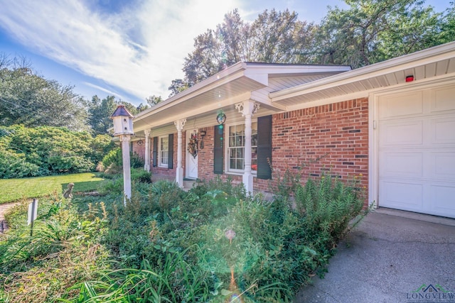 view of front of house featuring a porch and a garage