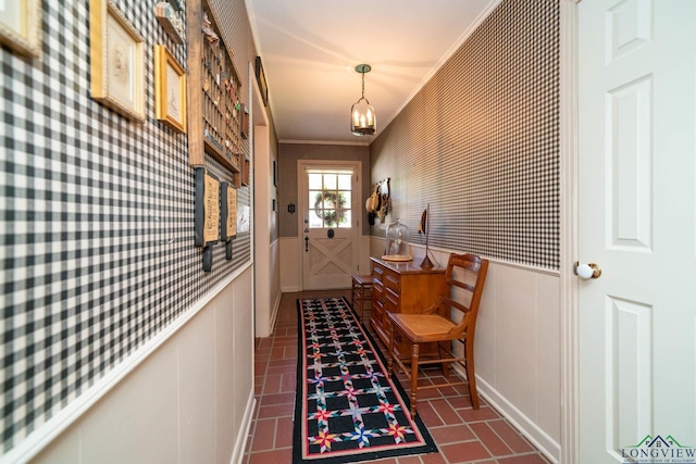 entryway featuring an inviting chandelier and ornamental molding