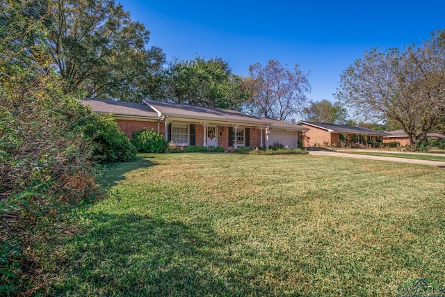 ranch-style home with a front yard and a garage