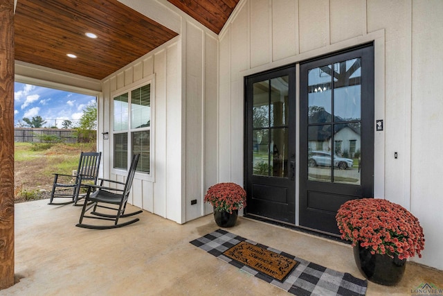 view of exterior entry with a porch