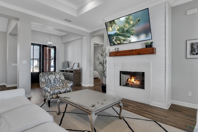 living room with ornamental molding and wood-type flooring