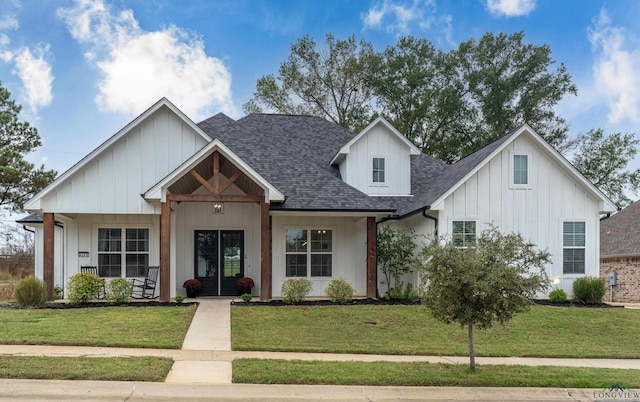 4205 Savannah Hills Ln, Longview, TX 75605 - modern farmhouse style home featuring a shingled roof, a front lawn, a porch, and board and batten siding