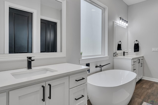 bathroom featuring vanity, a bathing tub, and hardwood / wood-style floors