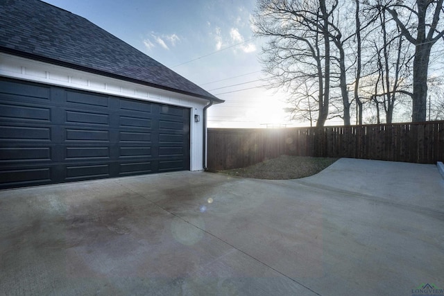 view of garage at dusk