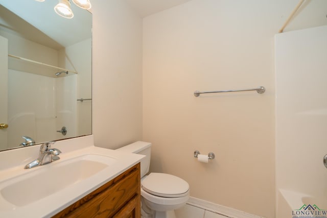 bathroom with tile patterned flooring, vanity, and toilet