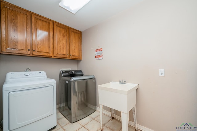 washroom featuring separate washer and dryer and cabinets