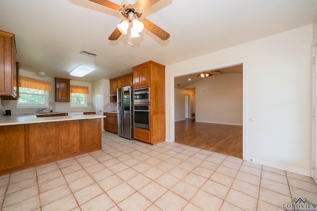 kitchen featuring kitchen peninsula, stainless steel fridge with ice dispenser, and ceiling fan