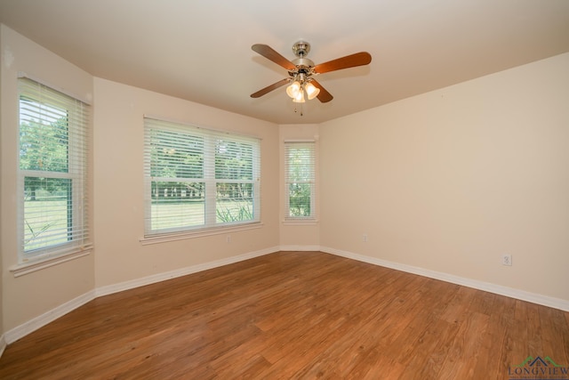 unfurnished room with ceiling fan and hardwood / wood-style flooring