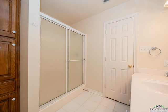 bathroom featuring tile patterned floors and a shower with shower door