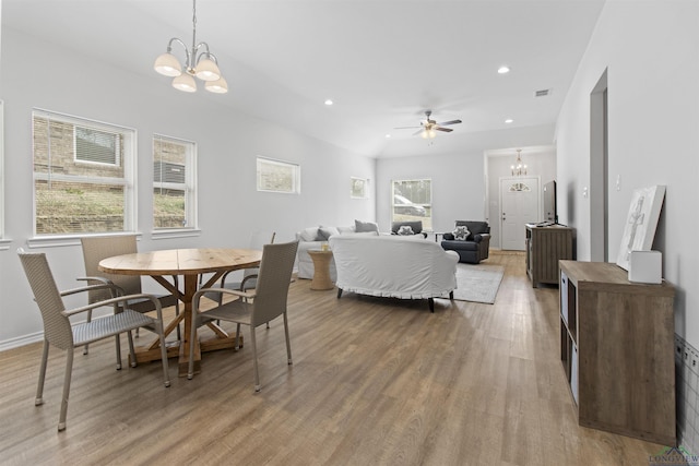 dining area featuring ceiling fan with notable chandelier and light hardwood / wood-style flooring