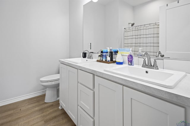 bathroom featuring hardwood / wood-style flooring, vanity, and toilet