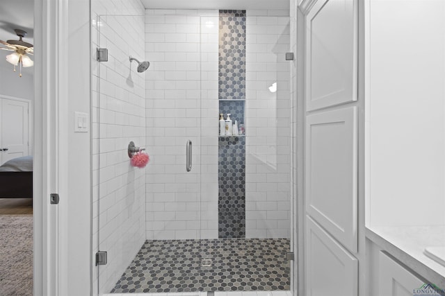 bathroom with an enclosed shower, vanity, and ceiling fan