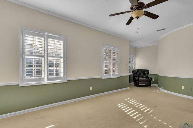 unfurnished room featuring ceiling fan, carpet, and ornamental molding