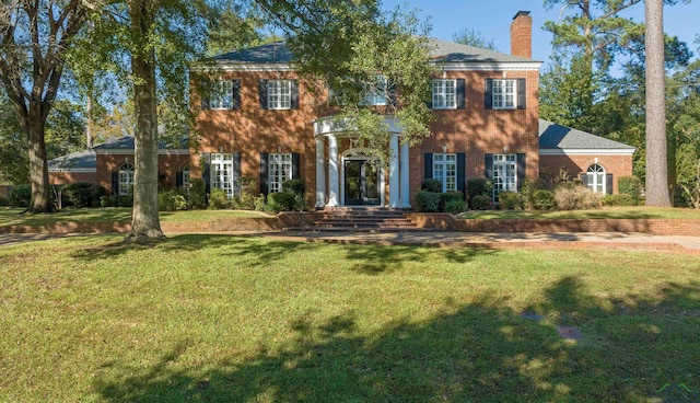 colonial-style house with a front yard