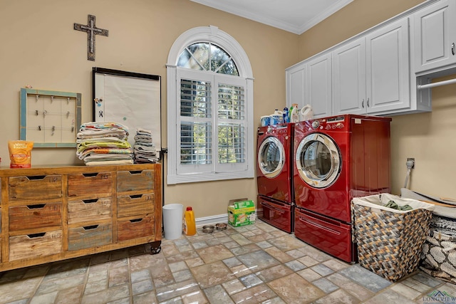 clothes washing area featuring cabinets, washer and clothes dryer, and crown molding