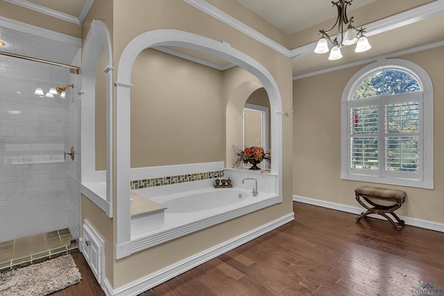 bathroom with a notable chandelier, ornamental molding, and shower with separate bathtub