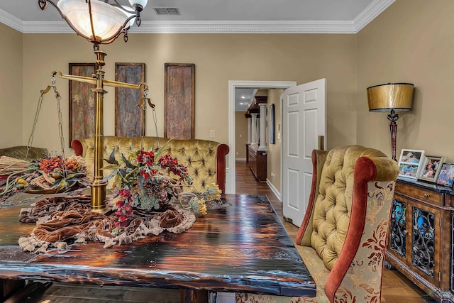 dining room with hardwood / wood-style floors and ornamental molding