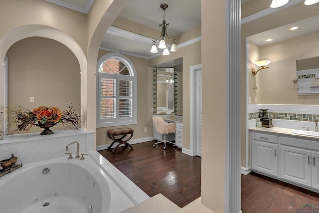 bathroom with hardwood / wood-style floors, vanity, crown molding, and a notable chandelier