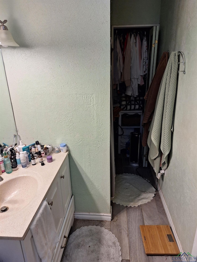 bathroom with vanity and hardwood / wood-style floors