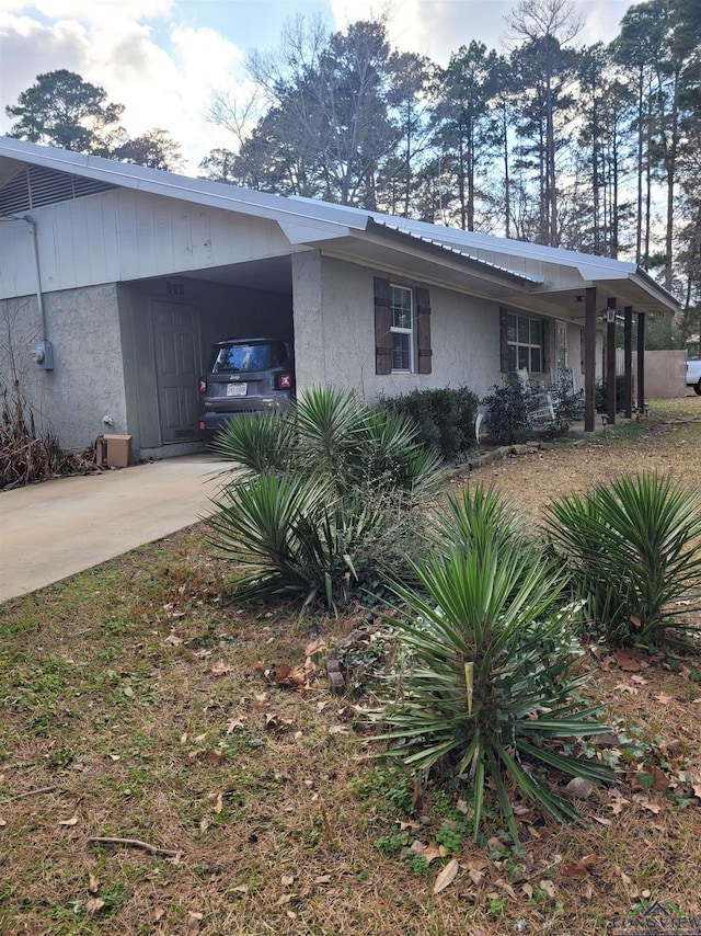 view of property exterior with a carport