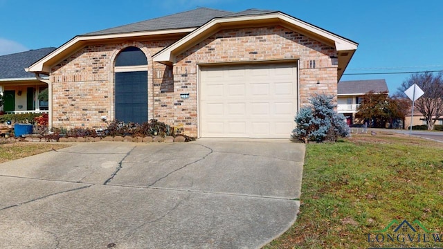 view of front of house with a front yard and a garage