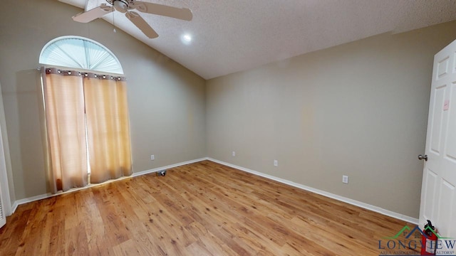 unfurnished room with light hardwood / wood-style floors, a textured ceiling, ceiling fan, and vaulted ceiling