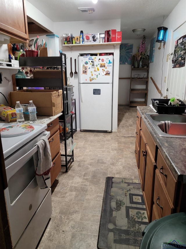 kitchen featuring sink and white appliances