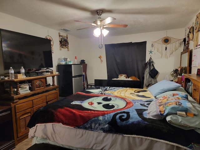 bedroom featuring ceiling fan and stainless steel fridge