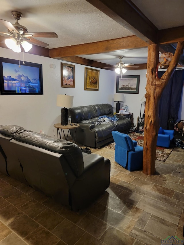 living room featuring beamed ceiling, a textured ceiling, and ceiling fan