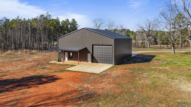 view of outbuilding with a garage and a porch