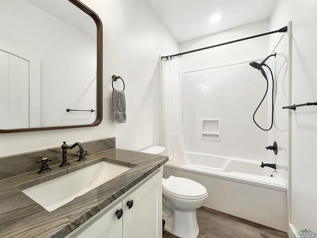 full bathroom with vanity, hardwood / wood-style flooring, toilet, and shower / bath combo with shower curtain