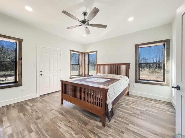 bedroom with ceiling fan and hardwood / wood-style floors