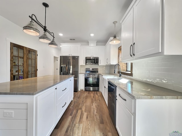 kitchen with white cabinetry, light stone counters, decorative light fixtures, and black appliances